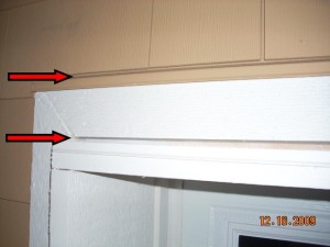 Horizontal joints left open above the window and trim
